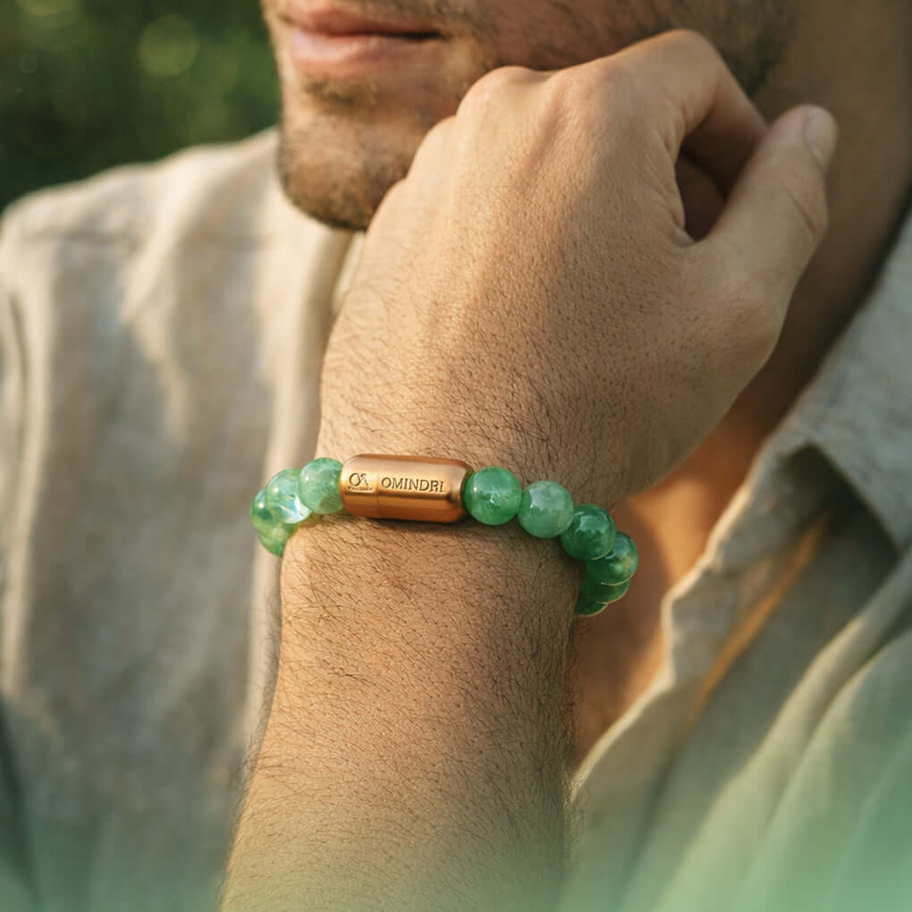 A man wearing a Magnet Green Aventurine Bracelet showcasing its green aventurine beads and magnetic component.