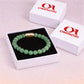 Magnet Green Aventurine Bracelet displayed in a gift box with gold clasp and black cushion background.