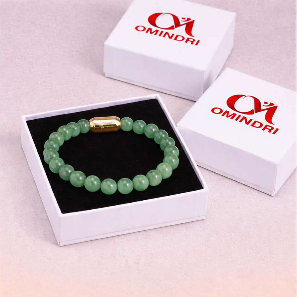 Magnet Green Aventurine Bracelet displayed in a gift box with gold clasp and black cushion background.