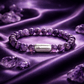 Magnet Amethyst Bracelet displayed on a soft purple surface with natural amethyst gemstone beads and a sleek silver centerpiece.