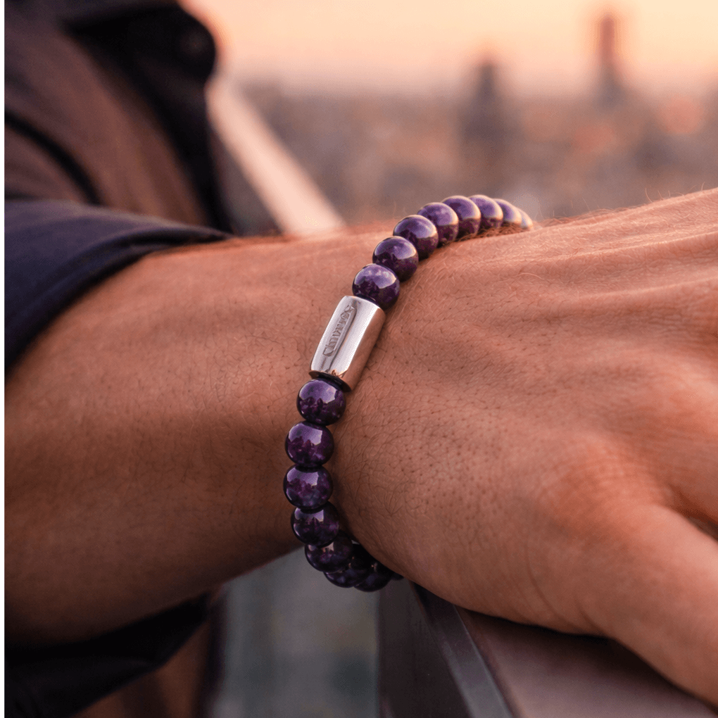 Magnet Amethyst Bracelet displayed on a man's wrist showcasing natural amethyst beads and modern elegance.
