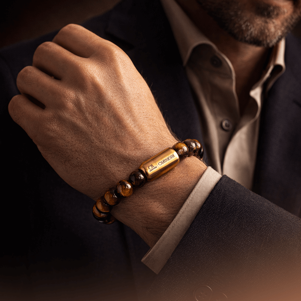 Magnetic tiger eye bracelet worn on a man's wrist, showcasing natural gemstones and a stylish design.