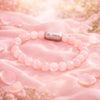 Magnet Rose Quartz Bracelet featuring natural rose quartz stones on a soft pink background.